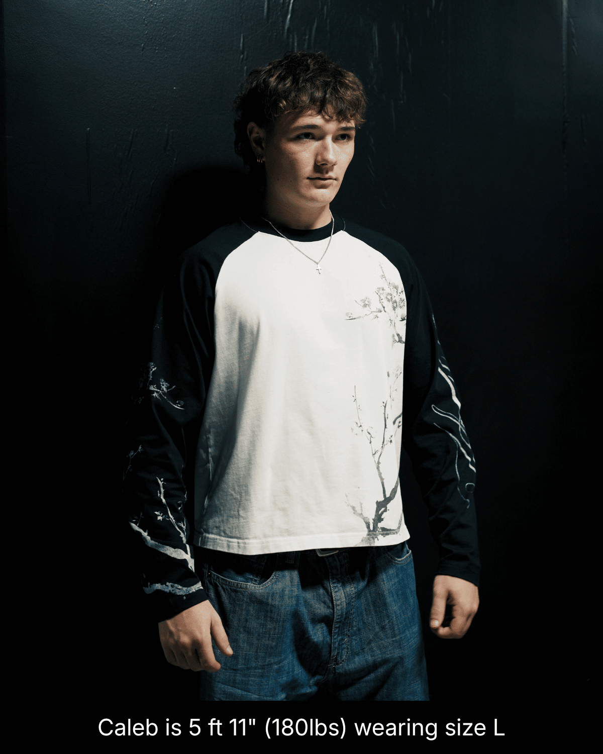 Model wearing the black and white John 15:5 long sleeve shirt in size L, front view.