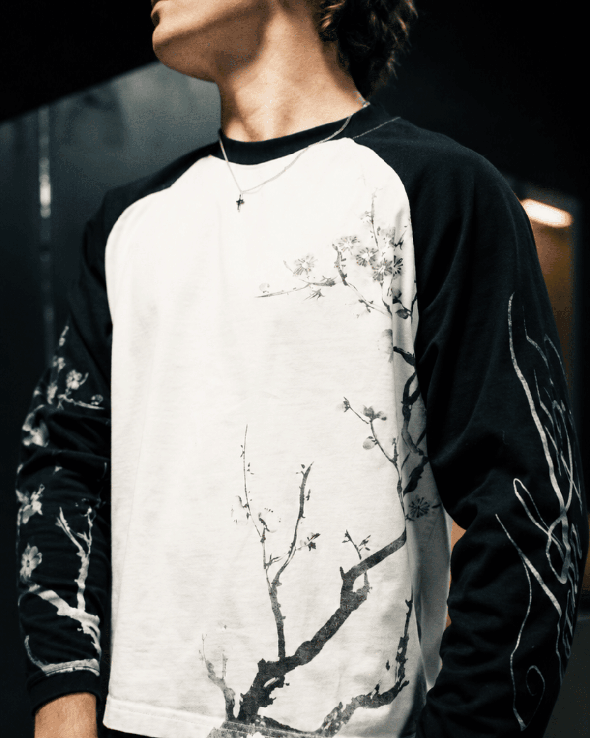 Close-up of the floral branch print and contrasting sleeves on the black and white John 15:5 long sleeve shirt.