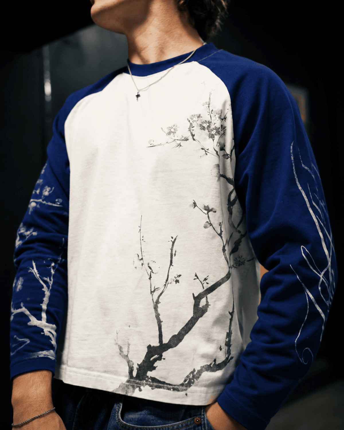 Close-up of the floral branch print and contrasting sleeves on the blue and white John 15:5 long sleeve shirt.