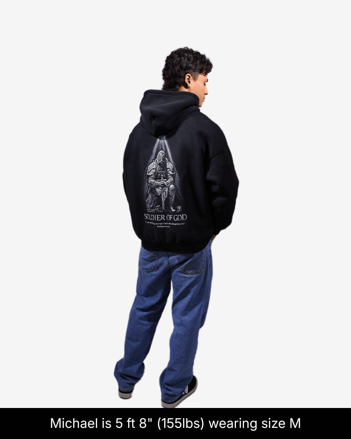 Model wearing black Soldier of God hoodie, showing a kneeling armored knight graphic on the back in size M.